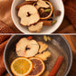 Spiced Chai Latte simmer blend with dried apple, orange, cinnamon, ginger and whole spices, shown dry in a bowl and simmering in water.
